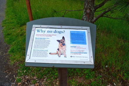 Sign explaining why dogs are not permitted in the nature park - service animals only Sign explaining why dogs are not permitted in the nature park - service animals only